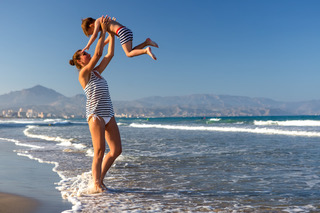 A Mother and her son is having fun at seashore of Mediterranean sea