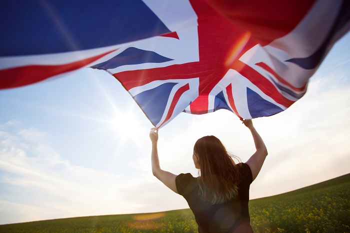 Young,Woman,Holding,Waving,Union,Jack,Flag.