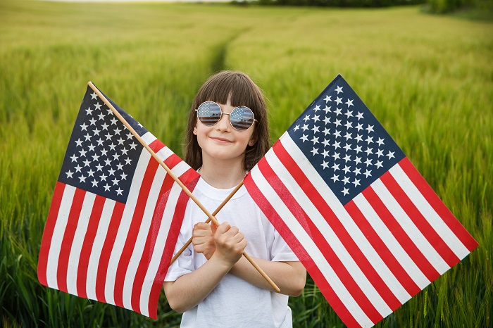 Pretty,Young,Pre-teen,Girl,In,Field,Holding,American,Flag.,Independence