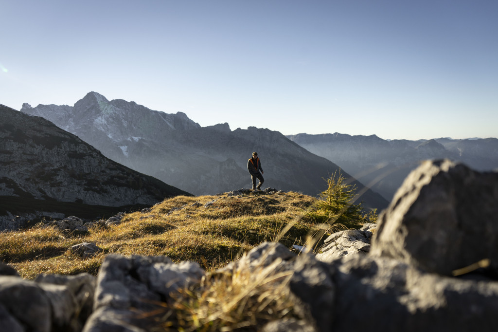 Person climbing the mountains around Watzmannhaus on a sunny day